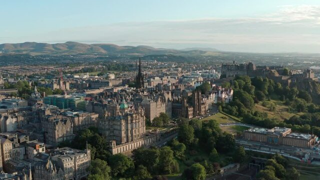 Rising drone shot over Edinburgh old town at sunset