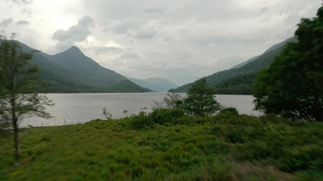 Low drone shot over small island in Scottish Loch leven
