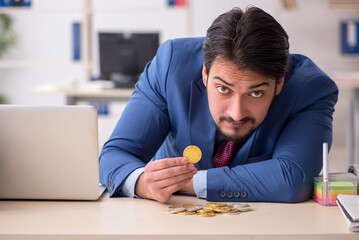 Young man earning money via Internet in cryptocurrency concept