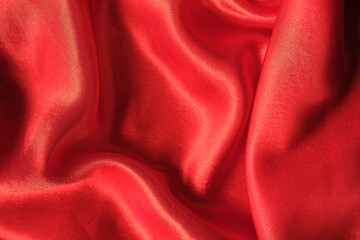 abstract texture of draped red velvet background. eautiful textile backdrop. Close-up. Top view