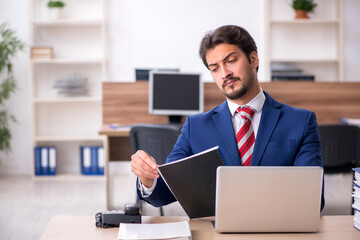 Young male employee working in the office