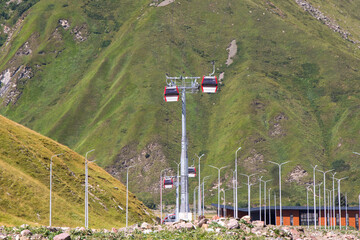 Air cabin and gondola lift transport, mountains and sunlight