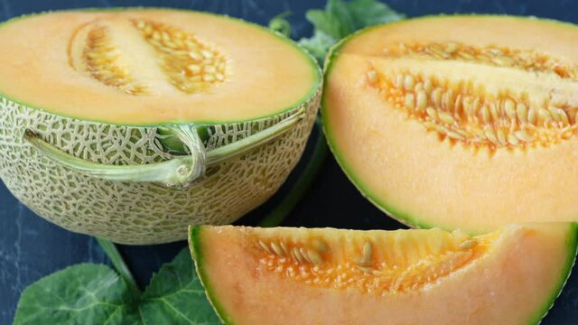 Top view Rotate Sweet Hokkaido melons on wooden table, Fresh Japanese Hokkaido melons very sweet and juicy.