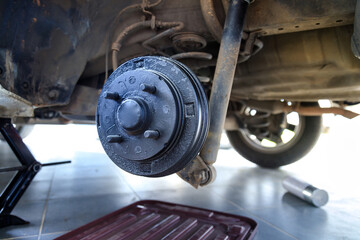 A rear hub of the car after removing a tire and wheel, maintaining a brake and wheel system, car...