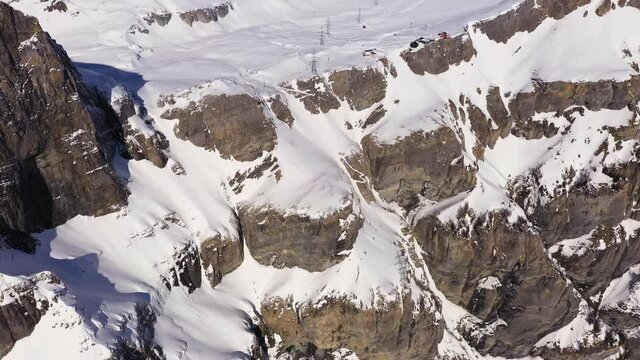 Aerial drone footage of the famous Gemmi pass in the alps in Canton Valais above the Leukerbad station on a sunny winter day in Switzerland. Shot with a tilt up motion