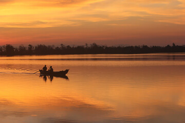 Two Fishermen friend returning after catching fish at beautiful dusk from river Sangu in Bandarban, Bangladesh 