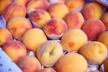 Fototapeta na wymiar collected sweet peaches in paper