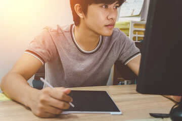 young business man using tablet while reading an e-mail on laptop on his desk at office, Business growth and bitcoin business concept