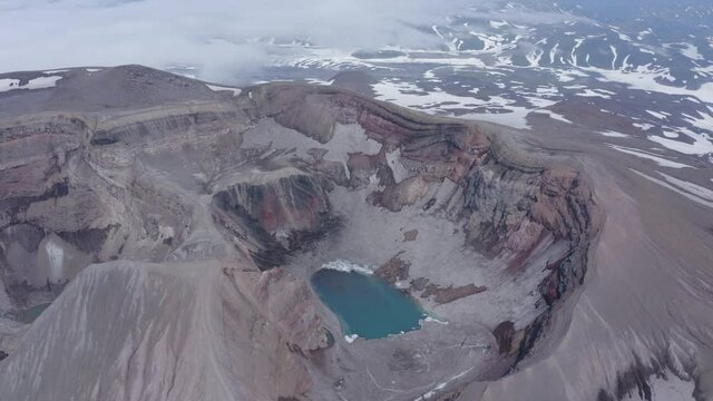 The crater of Gorely volcano with blue lake in it. Kamchatka Peninsula, Russia