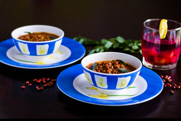 Black-eyed Pea also called Red Lobiya or Lobhiya in India,is a gravy based dish that has tomatoes and curry leaves.Served with local fruit juice called Kokum.Front view and closeup of the dish.