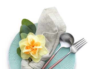 Beautiful table setting with narcissus flower on white background