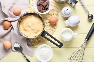 Ingredients for preparing churros on color wooden background