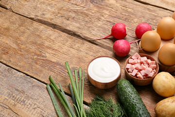 Different ingredients for okroshka on wooden background