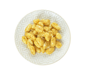 Plate with tasty pesto gnocchi on white background