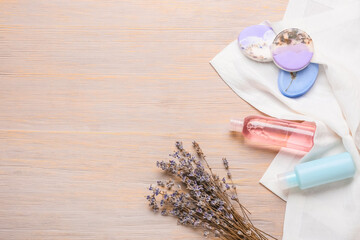 Obraz na płótnie Canvas Composition with soap bars, cosmetic products and lavender flowers on wooden background