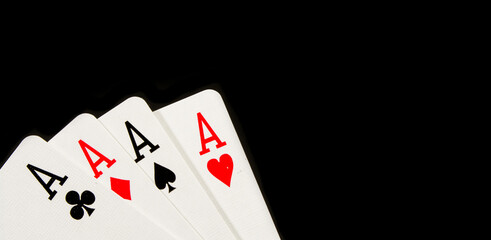 The combination of playing cards poker casino. Four aces on black background