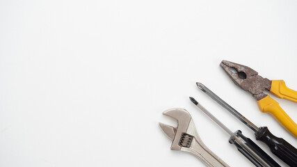 Adjustable wrench screwdriver pliers on white background top view,Technician tools on white background copy space