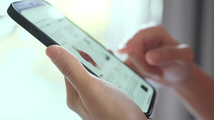 Woman online shopping on smart phone fashion clothes at home