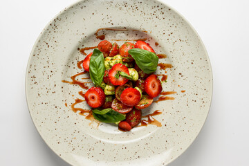 Salad with strawberries. Salad with mozzarella, tomatoes, basil and strawberries.