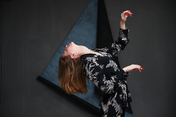 high resolution photo model girl with straight hair posing in studio looking up