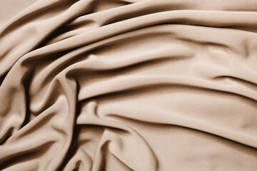 Smooth elegant beige satin texture as abstract background. Luxurious background design.