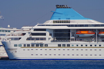 Modern white cruiseship cruise ship liner in port of Rhodes, Greece during summer Mediterranean...