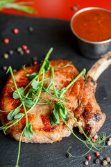 Grilled steak with french fries, tomato sauce and fresh arugula. Concept for a tasty and hearty meal.