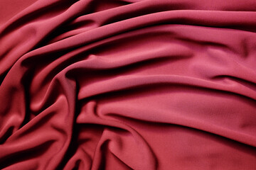Smooth elegant red satin texture can use as abstract background. Luxurious background design. Closeup texture