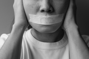 woman with mouth sealed in adhesive tape. Free of speech, freedom of press, Human rights, Protest dictatorship, democracy, liberty, equality and fraternity concepts