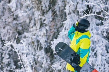 man in ski equipment with snowboard