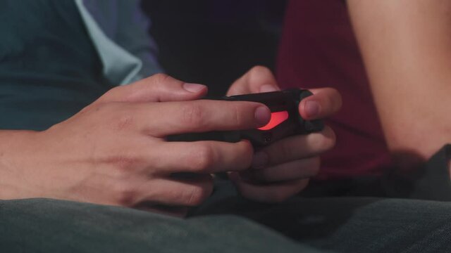 Close-up of a man's hand holding a joystick and playing video games. High quality 4k footage