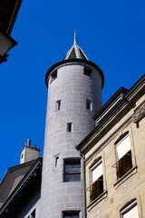 Medieval gray stone tower at the old town of Geneva on a sunny summer day morning. Photo taken July 29th, 2021, Geneva, Switzerland.