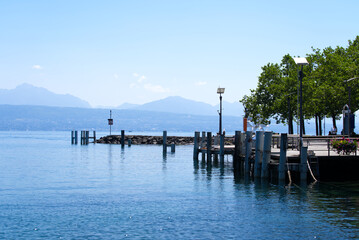 Obraz premium Idyllic pier at Lake Geneva on a sunny summer day. Photo taken July 29th, 2021, Lausanne, Switzerland.
