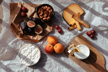 sunset picnic with various types of cheese and fruit