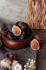 Wooden bowl with whole and halved figs