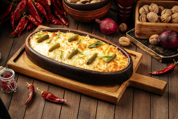 Georgian baked beef stew under cheese with pickles