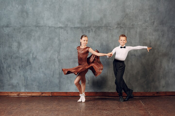 Young dancers boy and girl dancing in ballroom dance Samba.