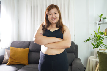 Fototapeta na wymiar Body confidence. Asian woman Overweight plus size woman wearing sportswear for exercising. self confident Body positive concept.