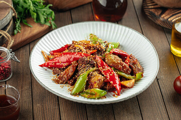 Asian cuisine roasted meat with peppers and sesame seeds