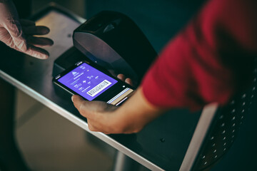 Passenger scanning boarding pass on phone at airport