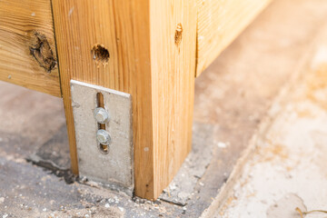 Fastening a timber frame to a concrete foundation