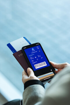 Traveler at airport using digital boarding pass phone app