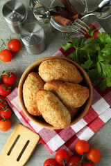 Concept of tasty food with cutlets on gray textured table