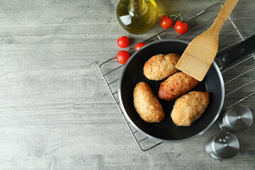 Concept of tasty food with cutlets on gray textured table