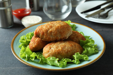 Concept of tasty food with cutlets on dark wooden table