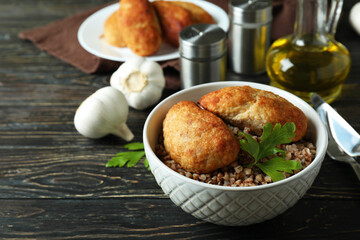 Concept of tasty food with cutlets on wooden table