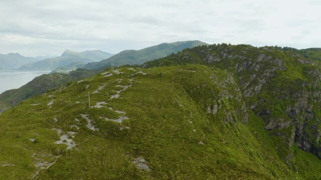 Moss-Covered Cliffs In Maaloy Village On A Cloudy Day In Vestland County, Norway. aerial