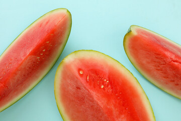 Ripe watermelon slices on blue background, top view