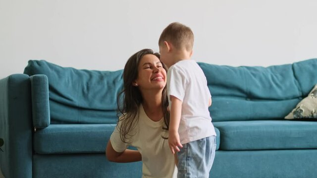 Happy mother day. child son congratulates mother on holiday and gives flowers. congratulating her on mother's day during holiday celebration at home
