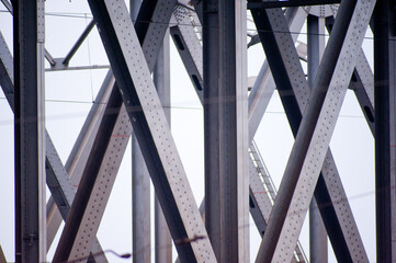 Close-up shot of metal elements of railway bridge supports.